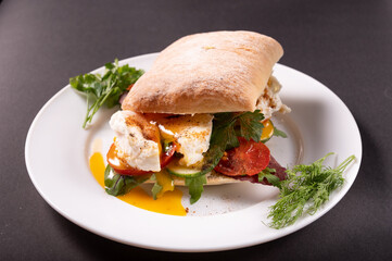 A sandwich with poached egg and herbs. Low-calorie breakfast with poached eggs. Diet dish.
