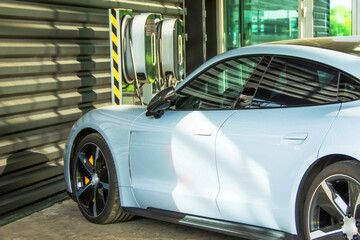 Passenger car near the garage next to the battery charging stations.