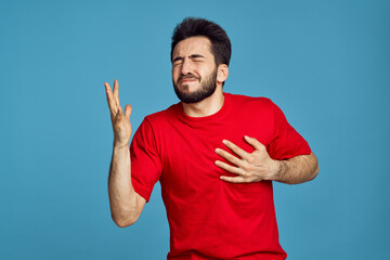 man in red t-shirt health problems emotions symptoms blue background