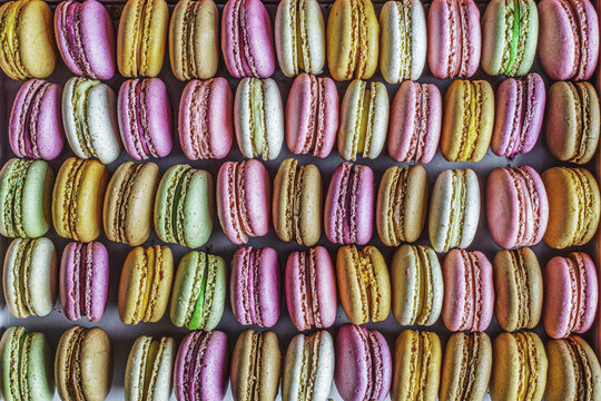 Colorful french macarons background, bakery concept.