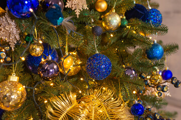 Obraz na płótnie Canvas Close up of balls on christmas tree. Bokeh garlands in the background. New Year concept.