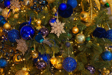 Obraz na płótnie Canvas Close up of balls on christmas tree. Bokeh garlands in the background. New Year concept.