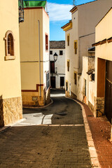 Obraz premium Narrow street and typical facades of Polop village