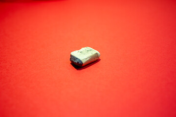 An old pencil eraser on a red background