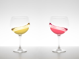 Glass of white wine and red wine swirling on a white background