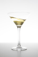 Vermouth glass in motion on white background