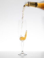 Champagne falling in glass on white background