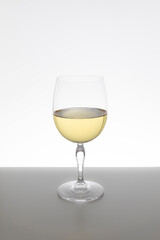 Glass of white wine on white background