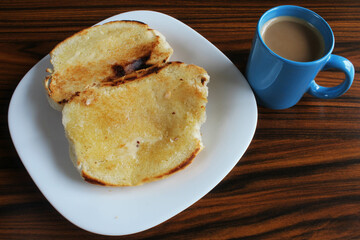 Coffee and milk and bread with butter. Brazilian breakfast.