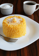 Brazilian breakfast. Couscous with coconut grated and coffee cup on the rustic table