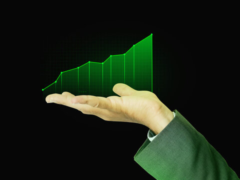 Green Growing Graph on Human Hand with Glow and Dark backdrop