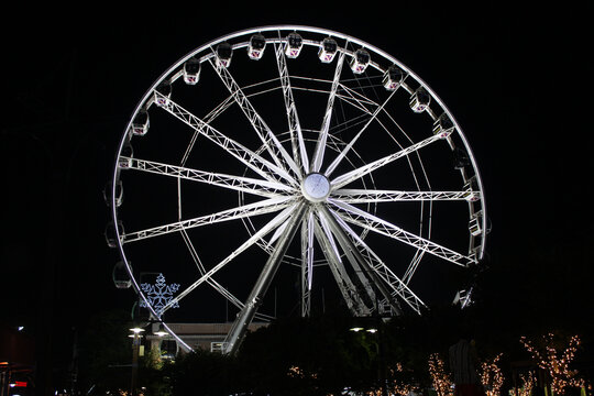 A large observation Ferris wheel illuminated at night in the Victoria and Albert Waterfront, Cape Town, Western Cape, South Africa
