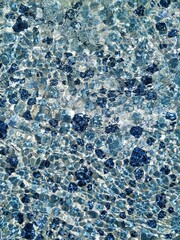 Play of the sunlight on the water surface in the mosaic pool