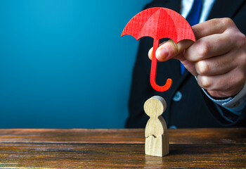 Insurance agent holds an umbrella over a men with a crack. Rehabilitation after trauma, drugs,...
