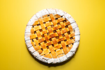 Tradition american Christmas apple pie with sugar crust top view on yellow background