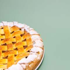 Tradition american Christmas apple pie with sugar crust on green background