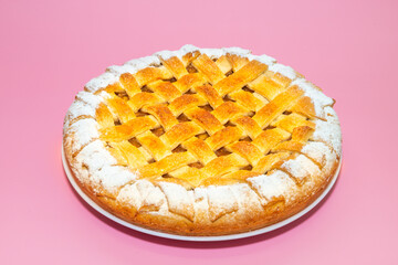 Tradition american Christmas apple pie with sugar crust on pink background