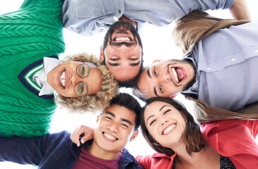 Multiracial group of friends having fun. Group of people standing in circle smiling looking at the camera and laughing. Concept of friendship.