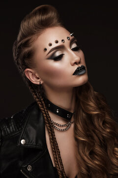 Portrait of a beautiful woman in a rock style image with creative makeup and hairstyle.