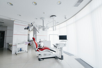 Beautiful modern and high-tech dental office in white tones. Dentistry. Microsurgery and prosthetics of teeth, treatment and teeth whitening. Radiology, panoramic scanner.