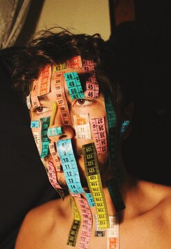 art portrait of young person with measuring tapes on face  *4