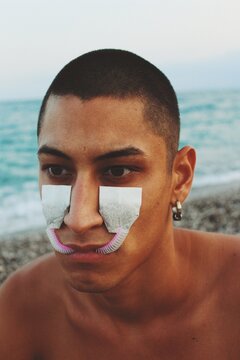 portrait of young man with teabags on face to cry tears that taste good *6
