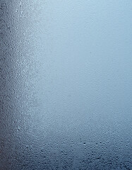Dull gray weather. Strongly fogged street window.