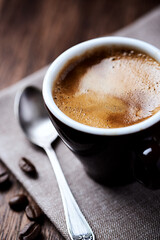 Cup of coffee on dark background. Close up.