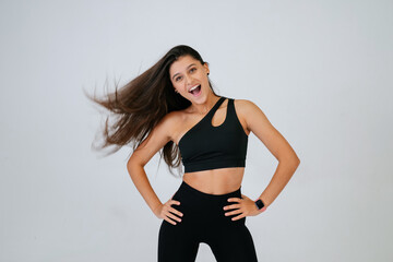 Sporty fit beautiful young woman in sportswear bra and black pants