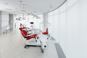 Beautiful modern and high-tech dental office in white tones. Dentistry. Microsurgery and prosthetics of teeth, treatment and teeth whitening. Radiology, panoramic scanner.