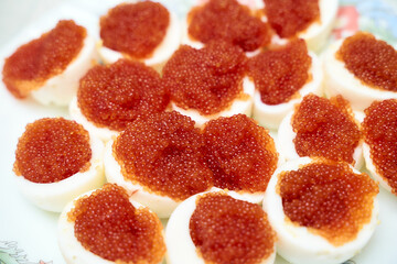 Pike roe salted in cut boiled eggs. Close Up