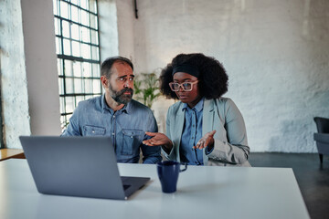 Couple dealing with their problems in online psychotherapy using laptop at home.