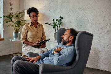 Mid age man having one counseling meeting with psychotherapist