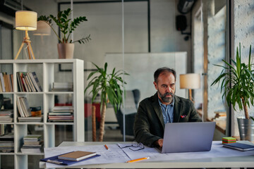 Businessman using laptop In modern office.