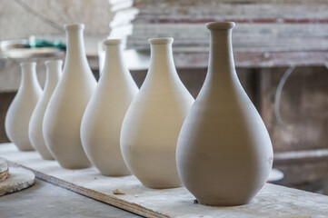 Fototapeta na wymiar a row of freshly made clay vases at a pottery