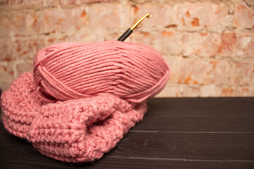 yarn and warm crochet yarn hat for crocheting on a dark table