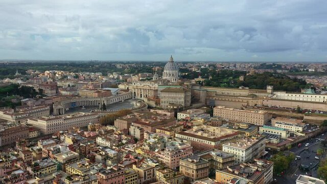 Aerial drone video of iconic masterpiece world famous Saint Peter Basilica and Sistine chapel in city of Vatican the biggest church in the world, Metropolitan city of Rome, Italy