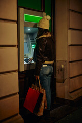 Woman at the ATM ready to withdraw cash money
