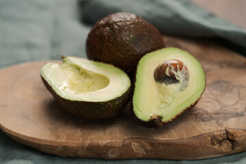 Ripe avocados on olive wood board