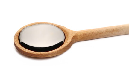 Soy sauce with wooden spoon isolated on white background