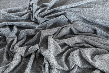 surface of silvery lurex fabric with pleats