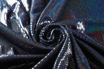 fabric with shiny rainbow sequins, coiled