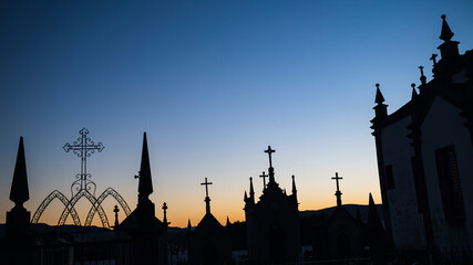 Fototapeta na wymiar Silhouettes of crosses in the cemetery during dawn.