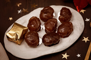 Glazed chestnuts,  traditional french sweets for winter holidays celebration. Cristmas dessert, festive dinner concept