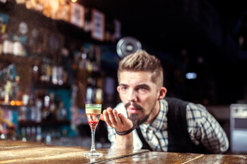 Young tapster demonstrates his professional skills in the bar