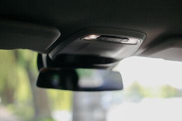 Overhead light in modern car interior.