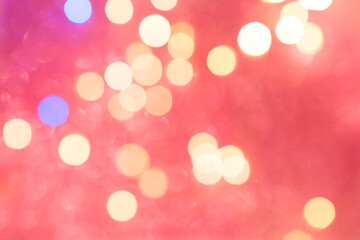 Beautiful calming coral color bokeh background. Happy New Year and Christmas backdrop with sparkling bokeh.