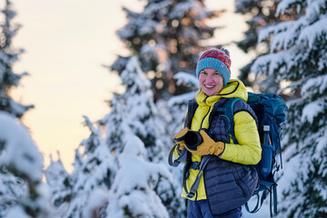 Fototapeta na wymiar Smiling happy woman in winter forest snowshoeing. Cypress Mountain ski resort. North Vancouver. British Columbia. Canada