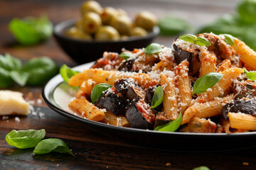 Pasta alla Norma with eggplant or aubergine, tomato, parmesan and basil. Healthy food