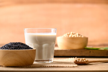 Soy milk with black sesame on wooden background, Healthy drink